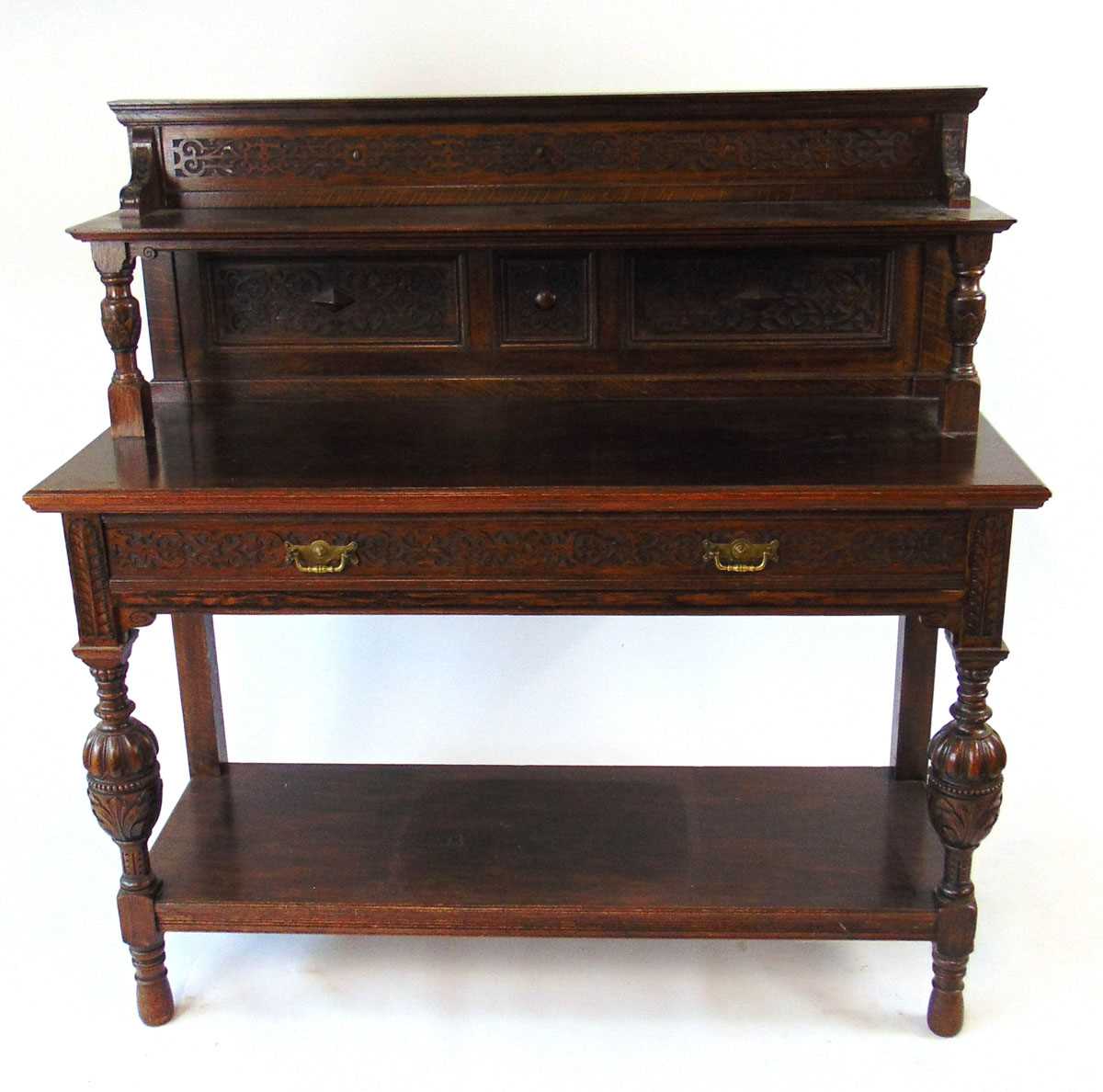 A late Victorian oak buffet, with blind fretwork decoration., a long frieze drawer, with bulbous cup - Image 2 of 3