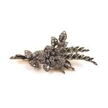 An early 20th century yellow and white metal diamond splay brooch with tremblant flowerhead. The