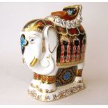 A Royal Crown Derby paperweight, modelled as a caparisoned elephant with howdah, with gold stopper