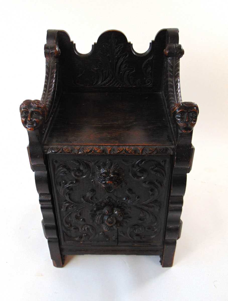 A late Victorian carved and ebonised oak purdonium/seat, decorated with carved masks, foliate - Image 2 of 14