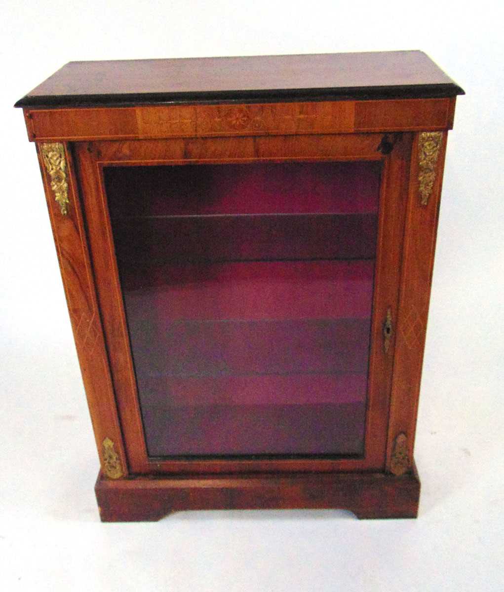 A Victorian walnut veneered vitrine, with bellflower and strung decoration, with applied gilt