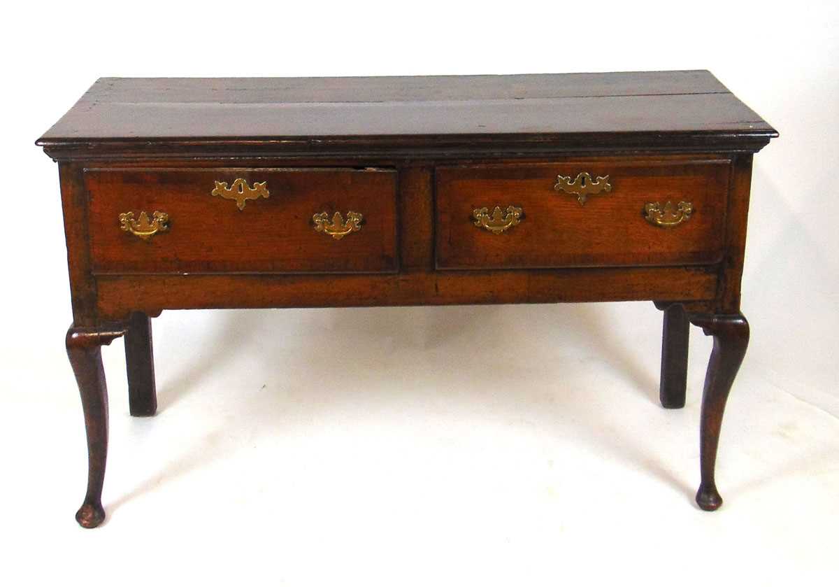 An 18th century oak and mahogany crossbanded dresser, the two plank top with moulded edge above