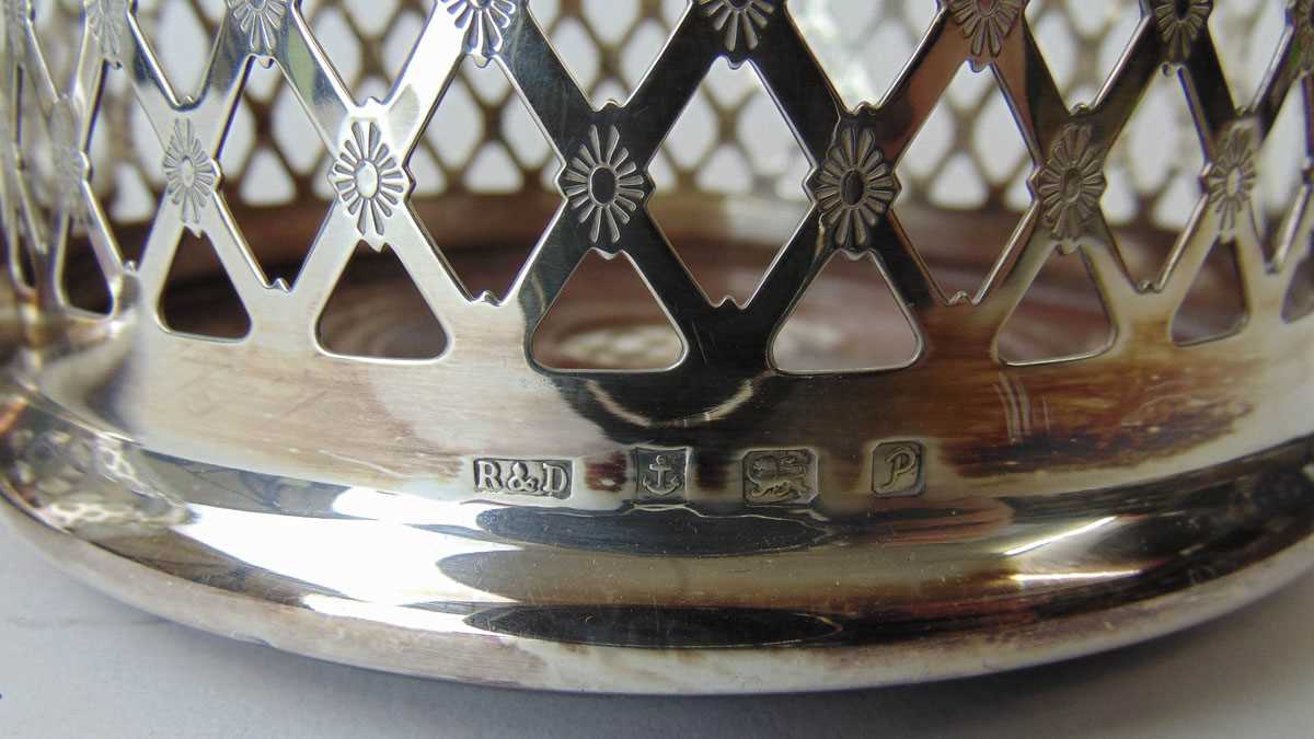 A pair of Elizabeth II silver pierced bottle coasters with turned wooden bases. Hallmarked for - Image 3 of 3