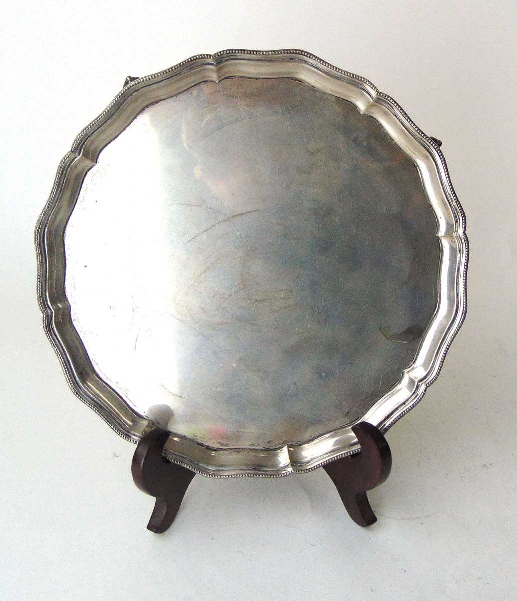 A sterling silver salver, Barker Bros Silver Ltd, Birmingham 1937, with beaded rim, on four claw &