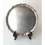 A sterling silver salver, Barker Bros Silver Ltd, Birmingham 1937, with beaded rim, on four claw &