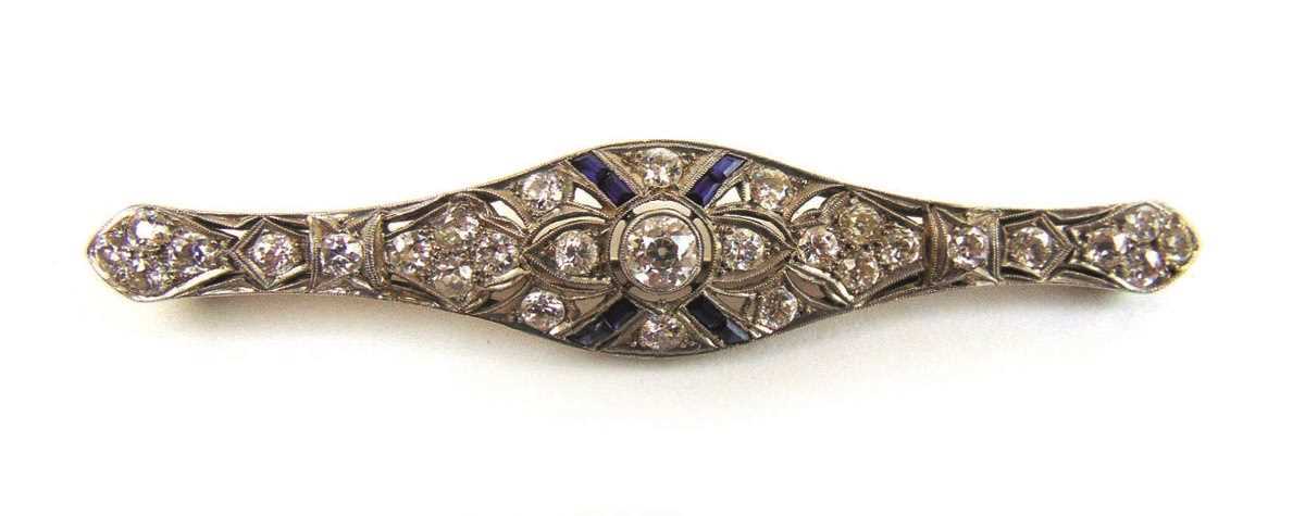An early 20th century diamond and sapphire bar brooch. Total diamond weight estimated in excess of