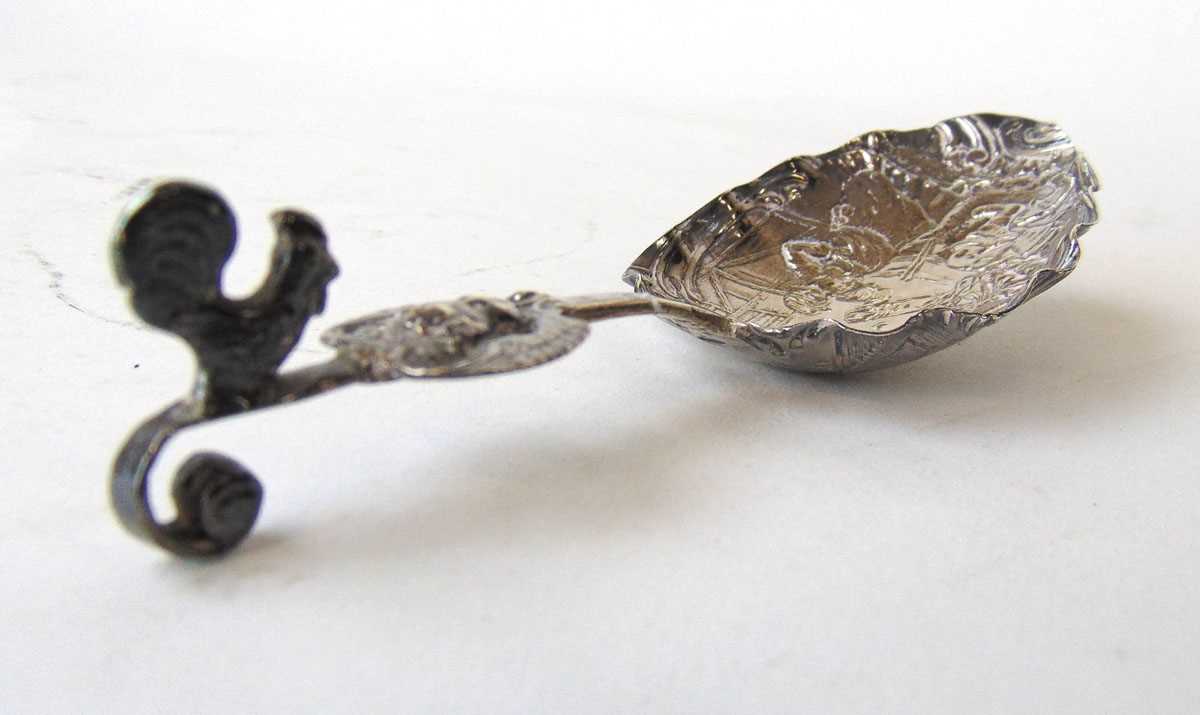A Dutch white metal spoon with embossed scenes of dancing. Approx. weight 29g, l. 14 cm. - Image 2 of 2