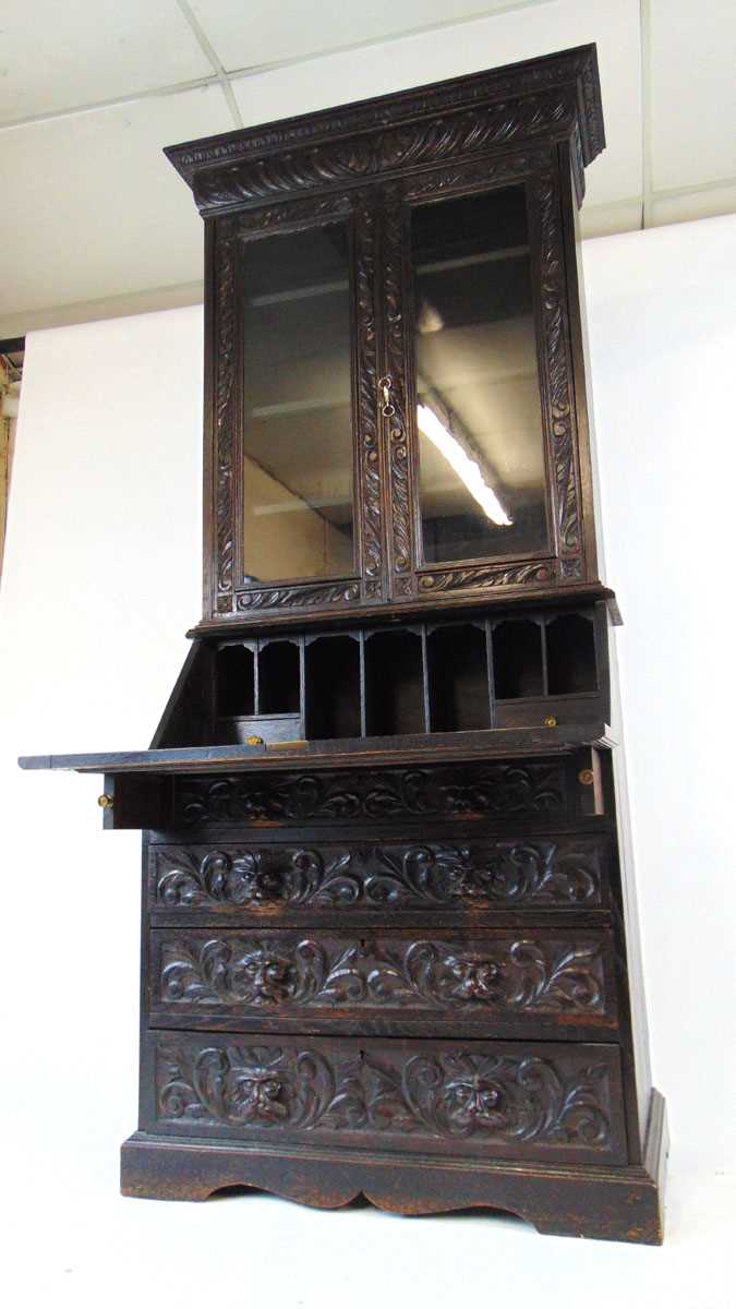 A late Victorian carved and ebonised oak bureau bookcase, the glazed doors enclosing adjustable - Image 5 of 5
