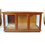 A Victorian mahogany shop display counter, the top with applied moulded edge above three glazed