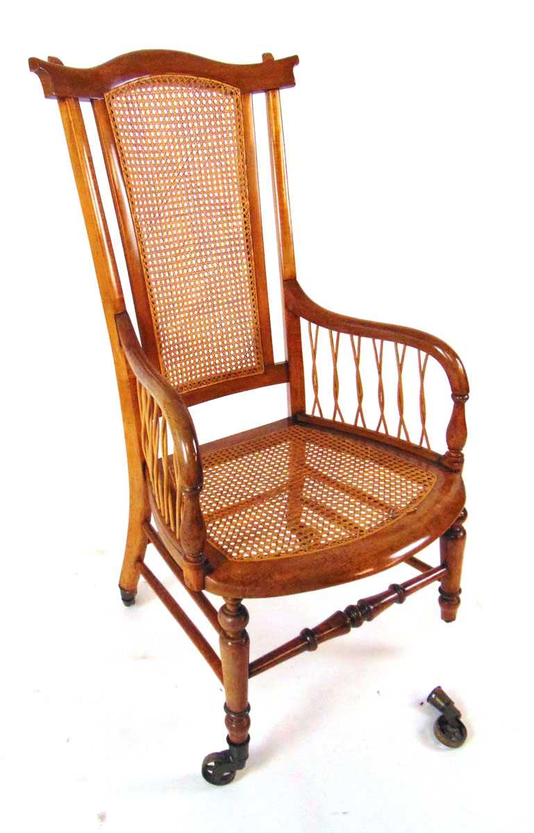 A Victorian beech bergere armchair, with shaped top rail, on brass castors, 109cm high - Image 3 of 4
