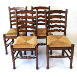 A set of four reproduction oak ladderback dining chairs, with drop in rush seats, 97.5cm high