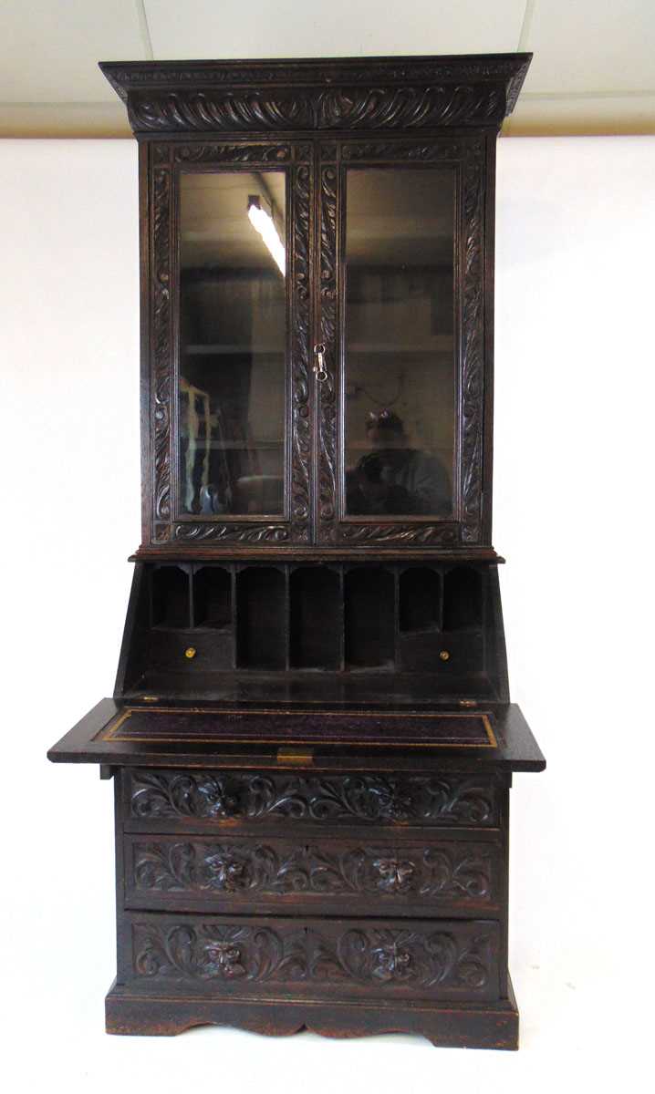 A late Victorian carved and ebonised oak bureau bookcase, the glazed doors enclosing adjustable - Image 4 of 5