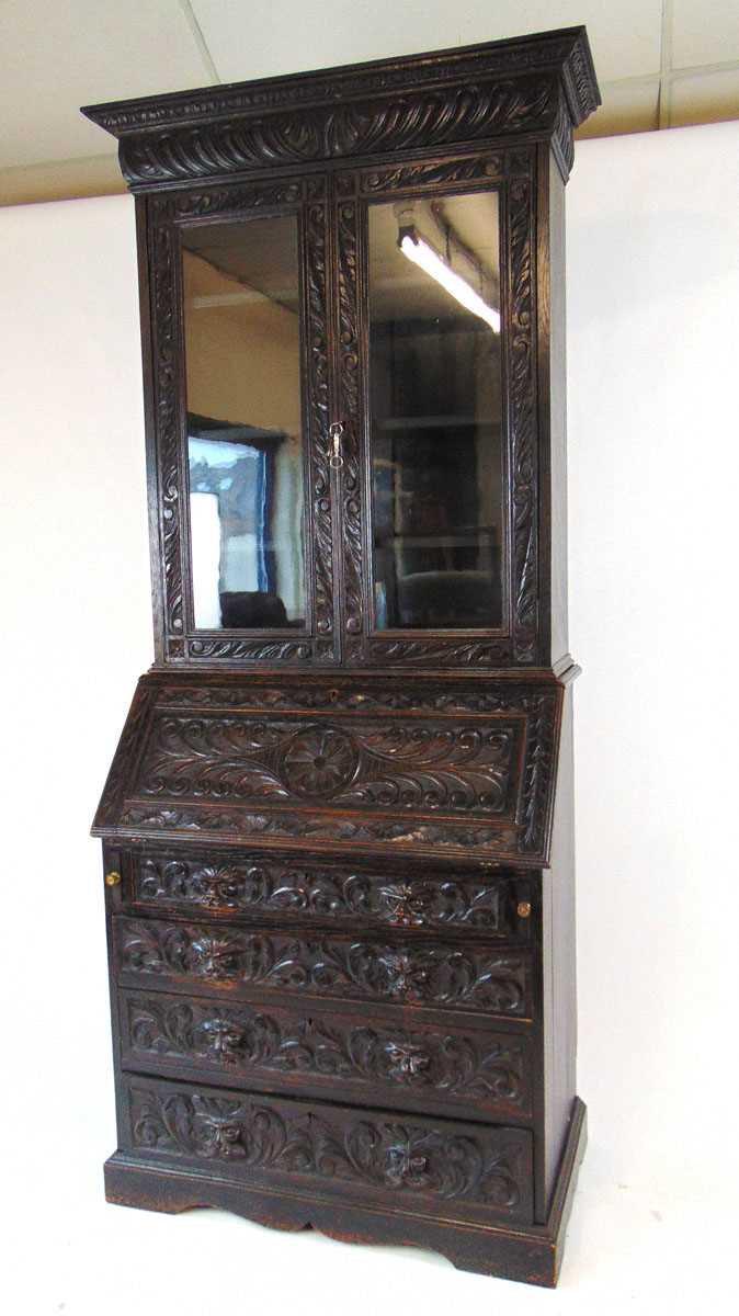 A late Victorian carved and ebonised oak bureau bookcase, the glazed doors enclosing adjustable - Image 3 of 5