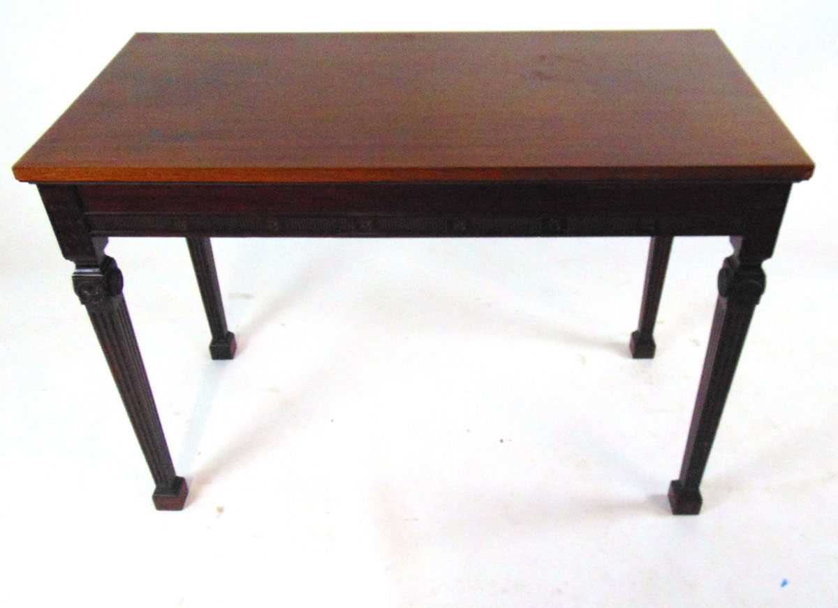 An Edwardian classical revival mahogany side table, of rectangular form, on square fluted legs on