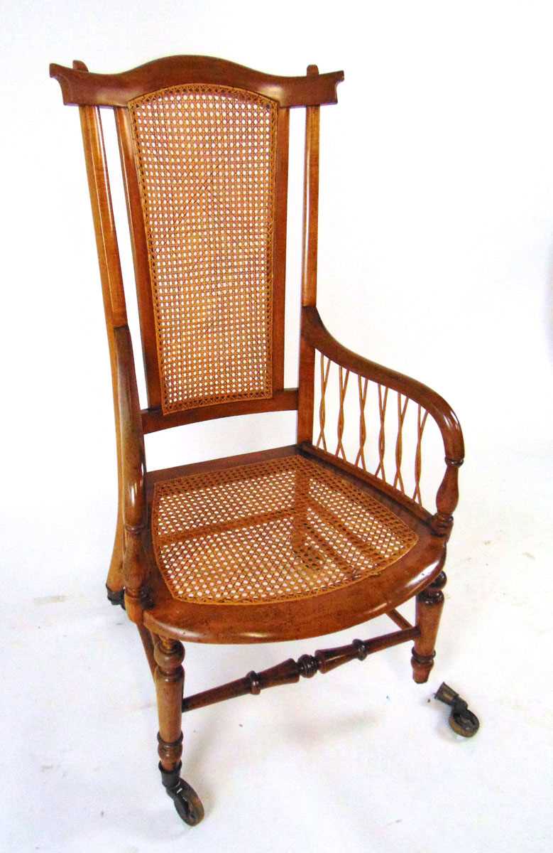 A Victorian beech bergere armchair, with shaped top rail, on brass castors, 109cm high - Image 2 of 4