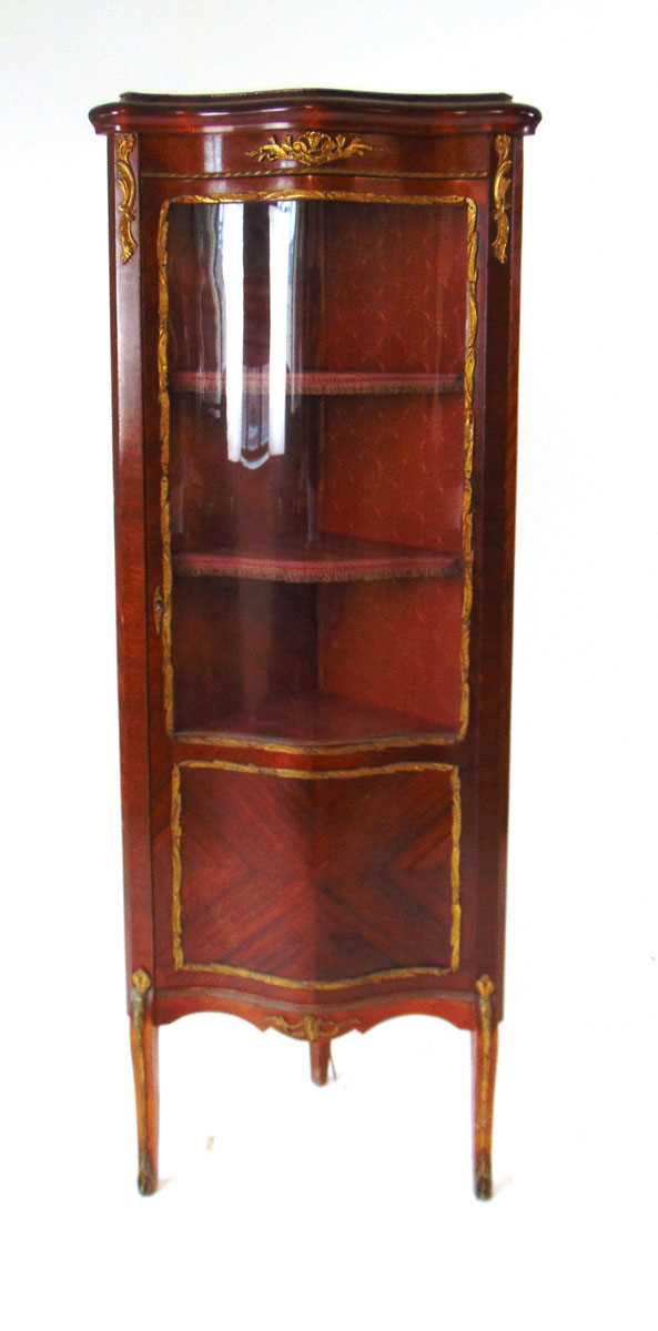 An early 20th century French Louis XV style serpentine fronted corner vitrine, with gilt metal