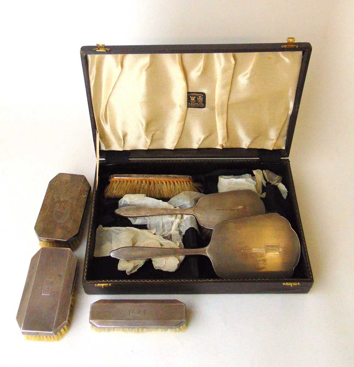 A George VI silver engine turned dressing table set together with a set of similar silver clothes