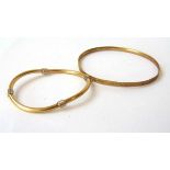 A yellow and white metal bracelet together with a bangle marked '9ct gold bronze core'. Weight of