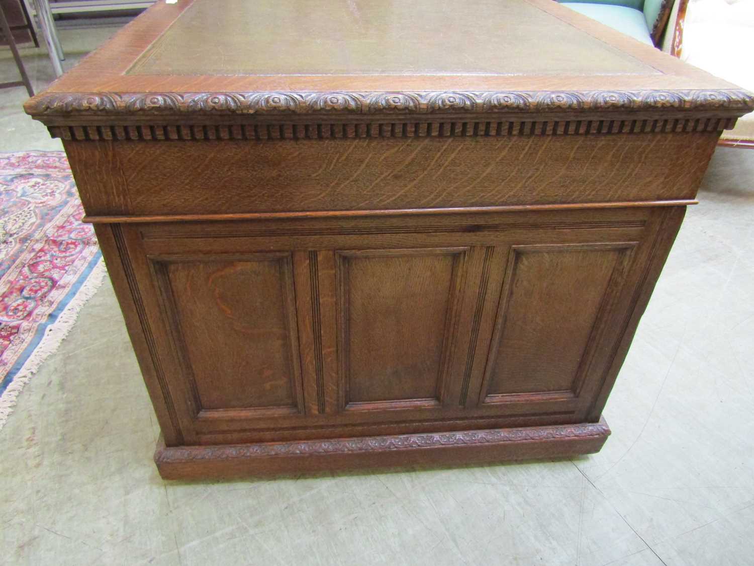 A late Victorian oak partners desk, with green tooled leather writing surface, above a series of - Image 11 of 15