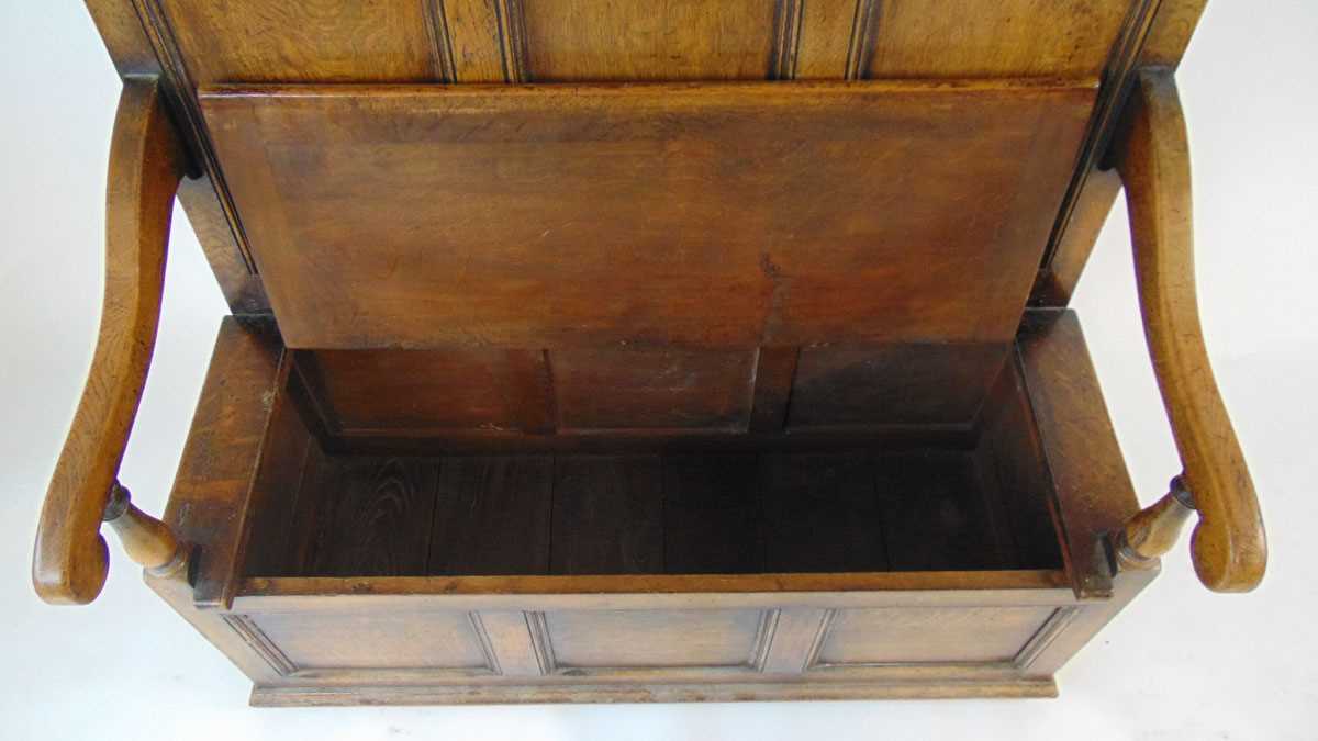An early 20th century reproduction oak box settle, with a narrow arcaded frieze above three - Image 5 of 7