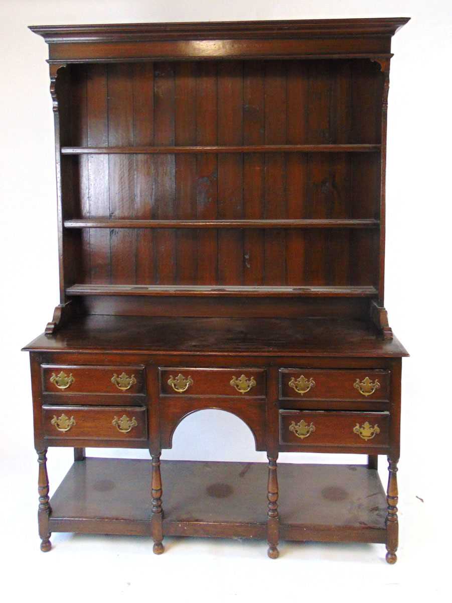 An early 20thn century reproduction oak Welsh dresser, the plate rack with boarded back, above the