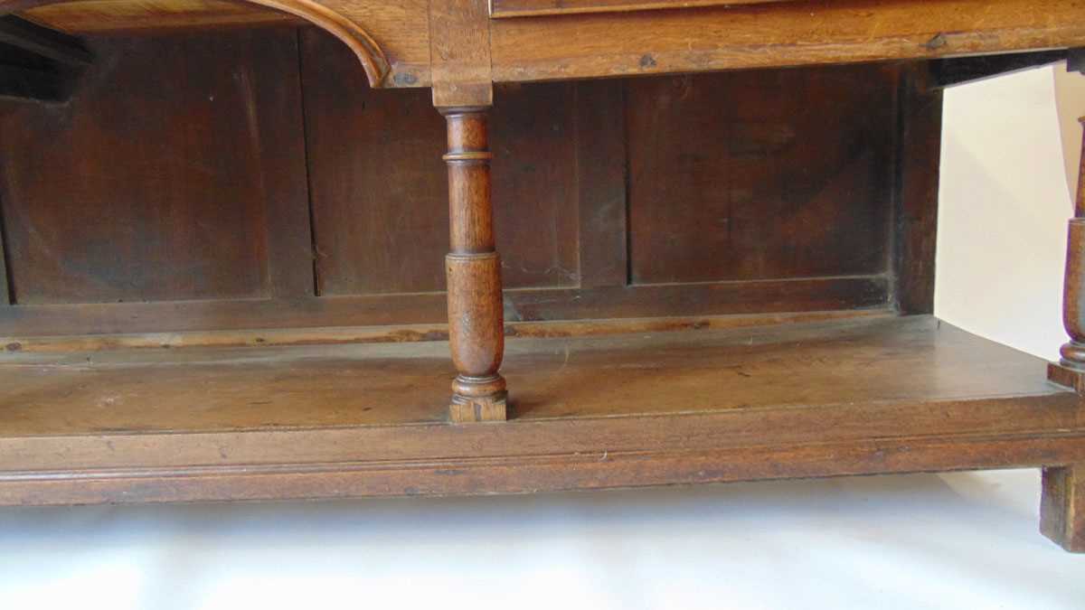 An 18th century oak dresser, with moulded pediment over three shelves and iron hooks, the base - Image 6 of 9