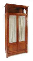 An early 20th century continental oak Art Deco display cabinet, with carved stylised leaves and