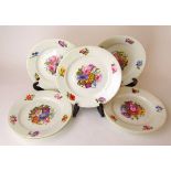 A set of seven early 19th century Derby type porcelain plates, decorated in the style of William