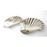 A pair of silver scallop shaped dishes, Horace Woodward & Co Ltd, London 1897, on three ball feet,