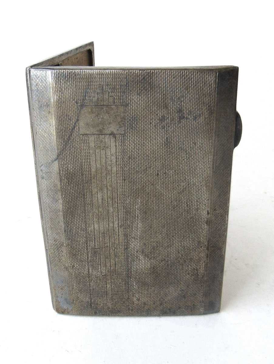 A silver cigarette case, Inman Manufacturing Co, Birmingham 1941, with engine turned decoration