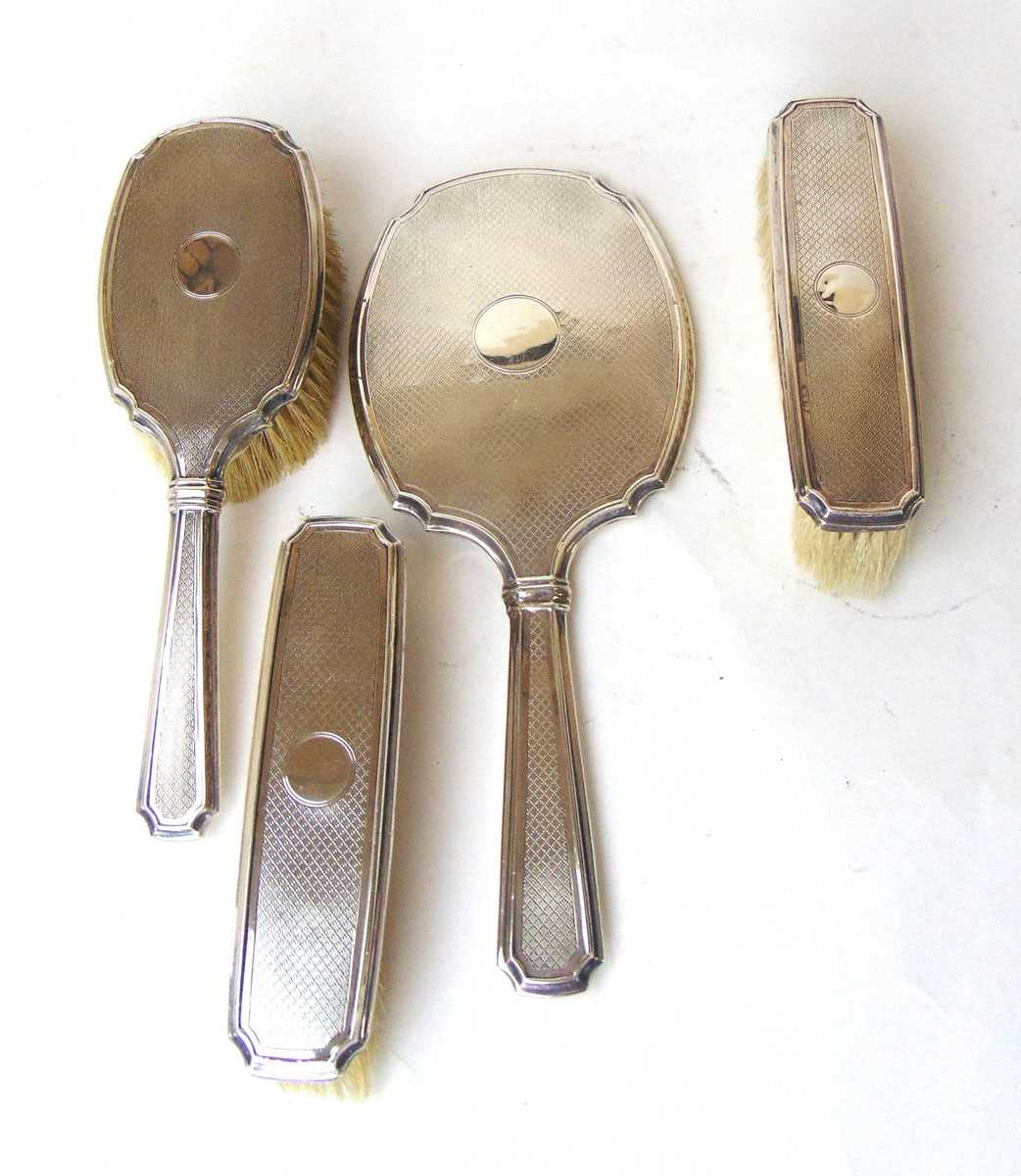 A silver backed four piece dressing table set, S Blanckensee & Son, Birmingham 1929, with vacant