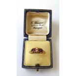 A mid Victorian 15ct gold, almandine garnet and pearl ring with openwork scrolling shoulders and