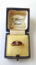 A mid Victorian 15ct gold, almandine garnet and pearl ring with openwork scrolling shoulders and