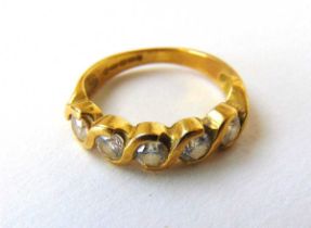 An 18ct gold and diamond ring, the five round brilliant stones totalling approximately 0.5ct. Size