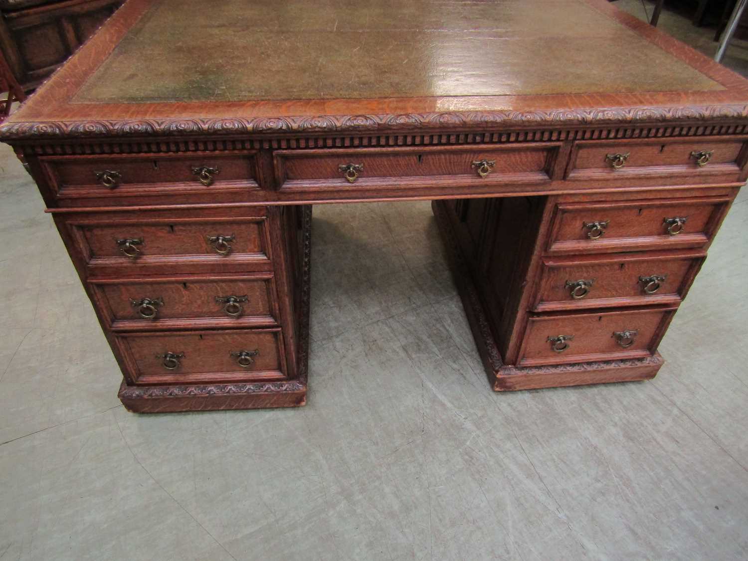 A late Victorian oak partners desk, with green tooled leather writing surface, above a series of - Image 12 of 15