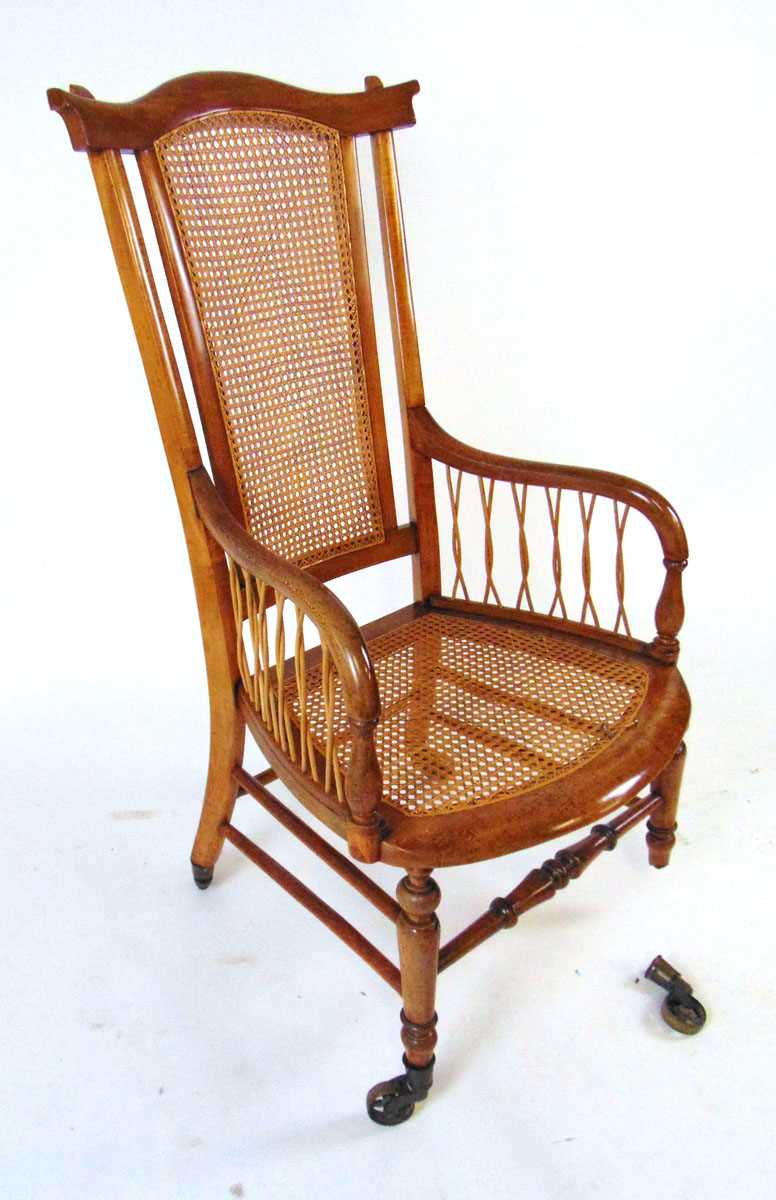A Victorian beech bergere armchair, with shaped top rail, on brass castors, 109cm high - Image 4 of 4
