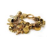 A 9ct gold charm bracelet suspending a variety of 9ct gold, yellow metal and base metal charms.