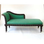A 19th century oak chaise longue, the frame with a continuous band of oval foliate carved bosses,