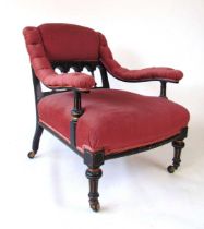 An Aesthetic period armchair, the part gallery back with turned spindles and shallow carved