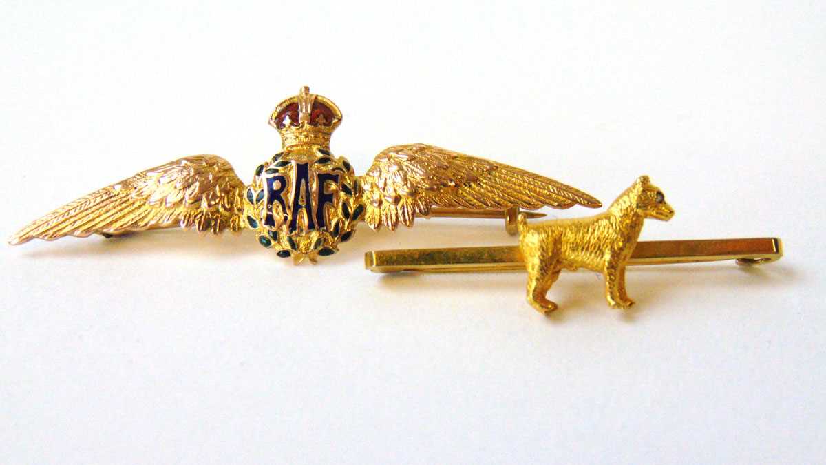 A yellow metal and enamel RAF sweetheart brooch marked '9ct' together with a 9ct gold dog brooch