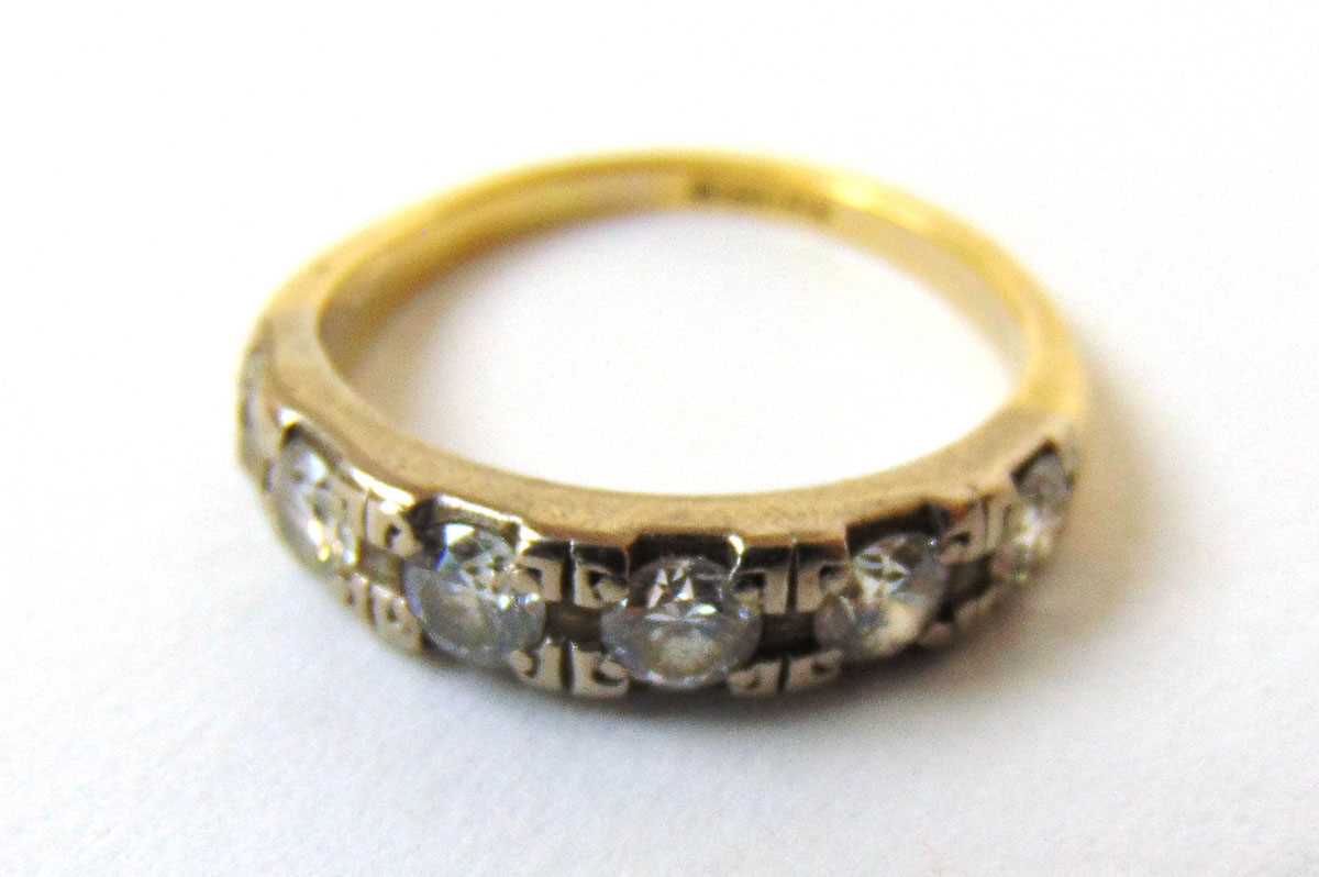 An 18ct gold and diamond half eternity ring. The five round brilliant stones totalling approximately