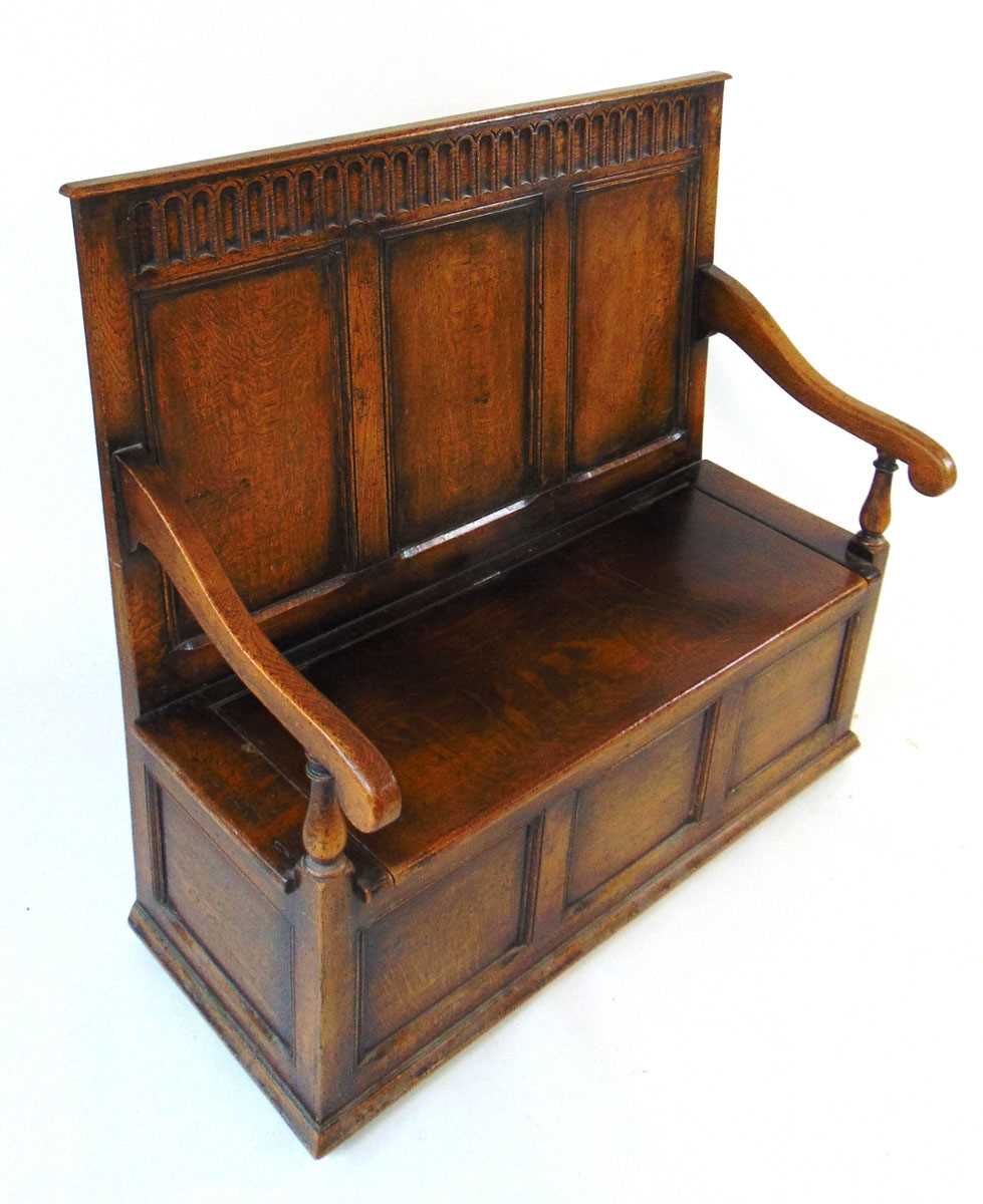 An early 20th century reproduction oak box settle, with a narrow arcaded frieze above three - Image 7 of 7