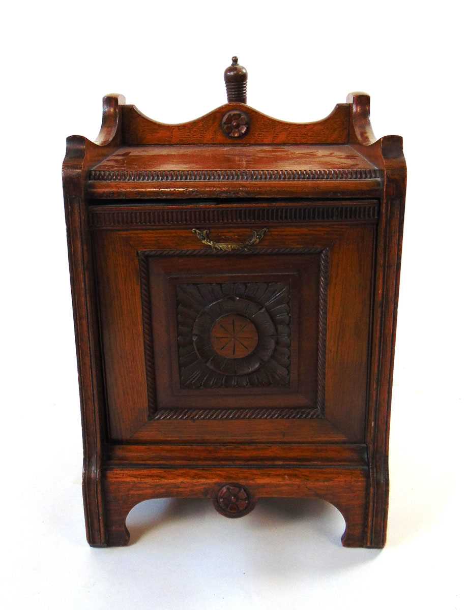 A Victorian Aesthetic period carved oak purdonium, with cast brass handles, 35cm wide, 50.5cm high