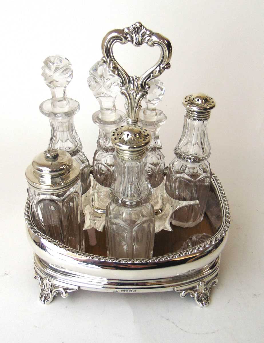 A Victorian silver seven bottle cruet stand, John Evans II, London 1846, with gadrooned rim on C