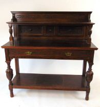 A late Victorian oak buffet, with blind fretwork decoration., a long frieze drawer, with bulbous cup