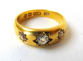 A Victorian 18ct gold and three stone diamond gypsy ring, the approximately 0.25ct central old cut
