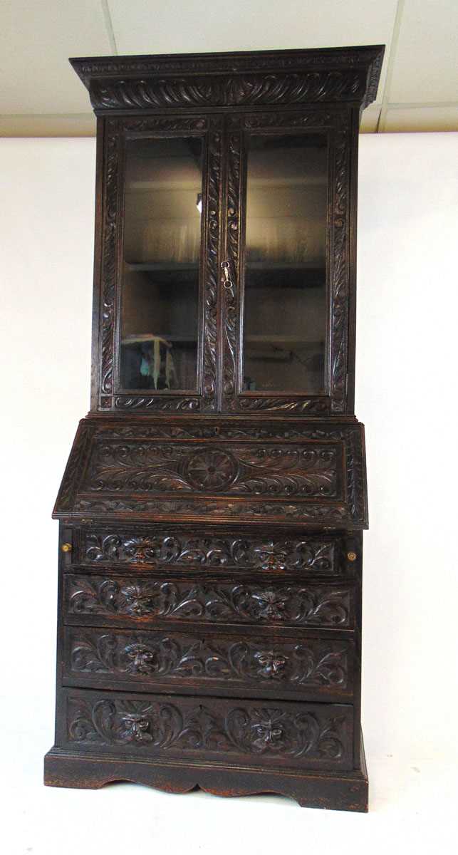 A late Victorian carved and ebonised oak bureau bookcase, the glazed doors enclosing adjustable - Image 2 of 5