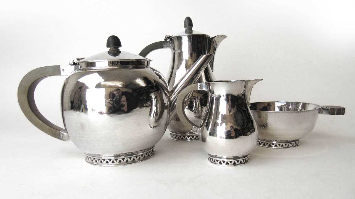 A George VI silver Arts & Crafts style four-piece tea and coffee set, the pieces having a textured