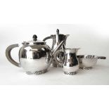 A George VI silver Arts & Crafts style four-piece tea and coffee set, the pieces having a textured