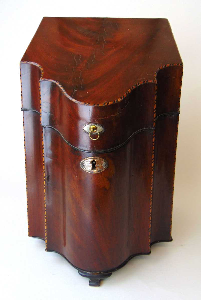 A George III mahogany and inlaid knife box, with serpentine front and fitted interior, with silver